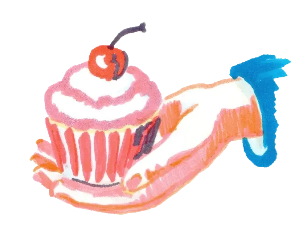 Someones hand offering a cupcake